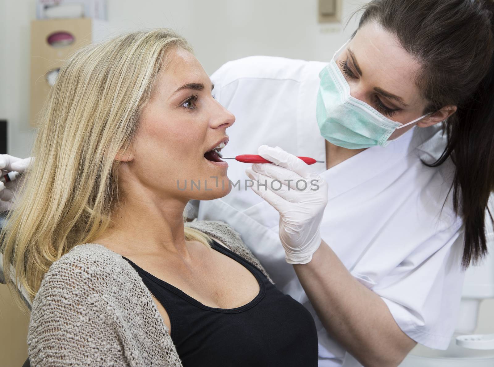 Female dentist and patient by gemenacom