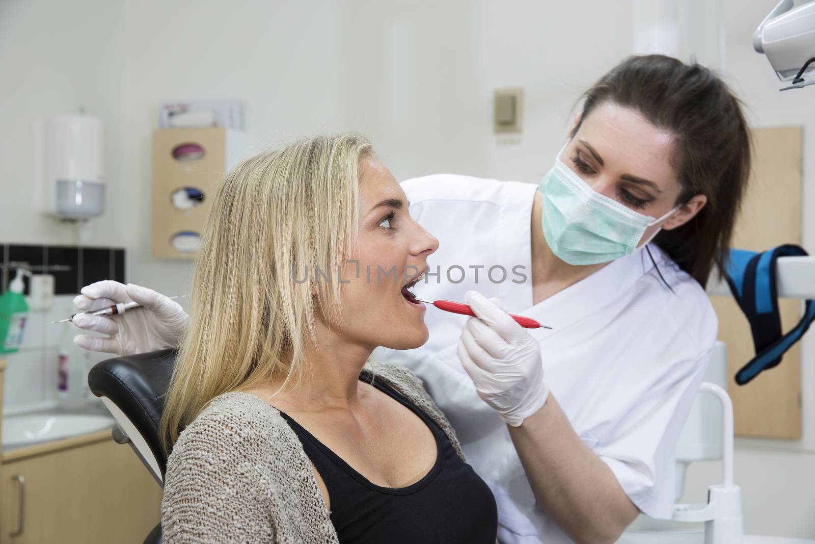 Female dentist and patient by gemenacom
