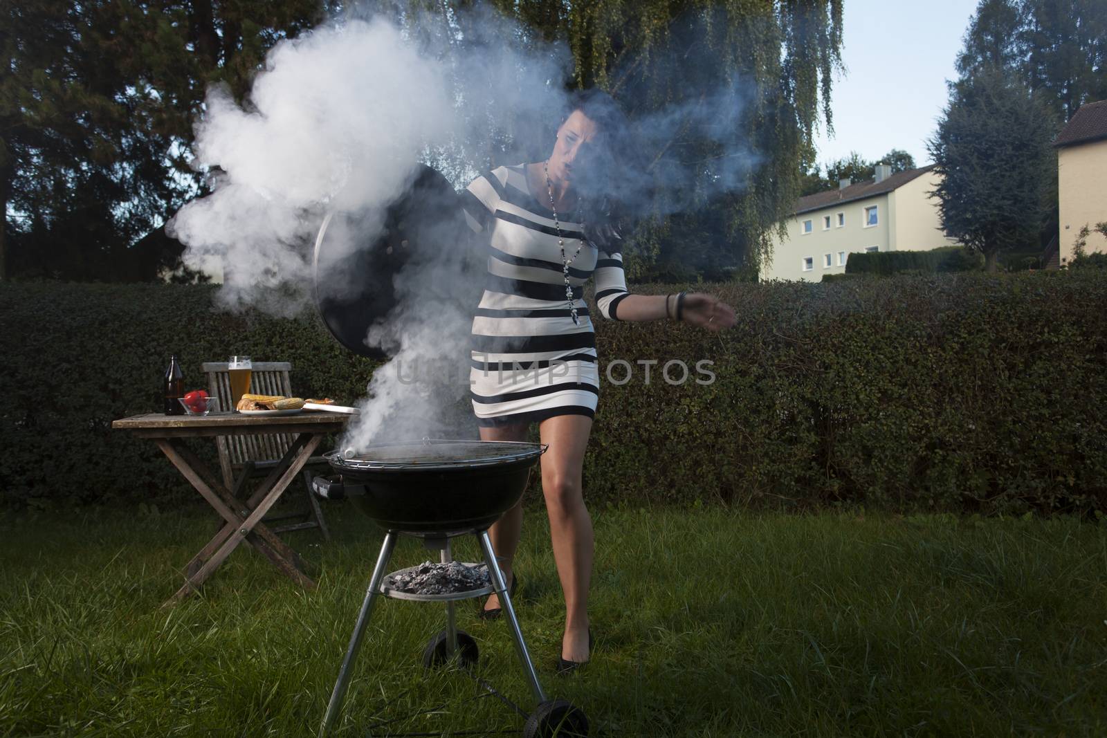 woman cooking on the barbecue