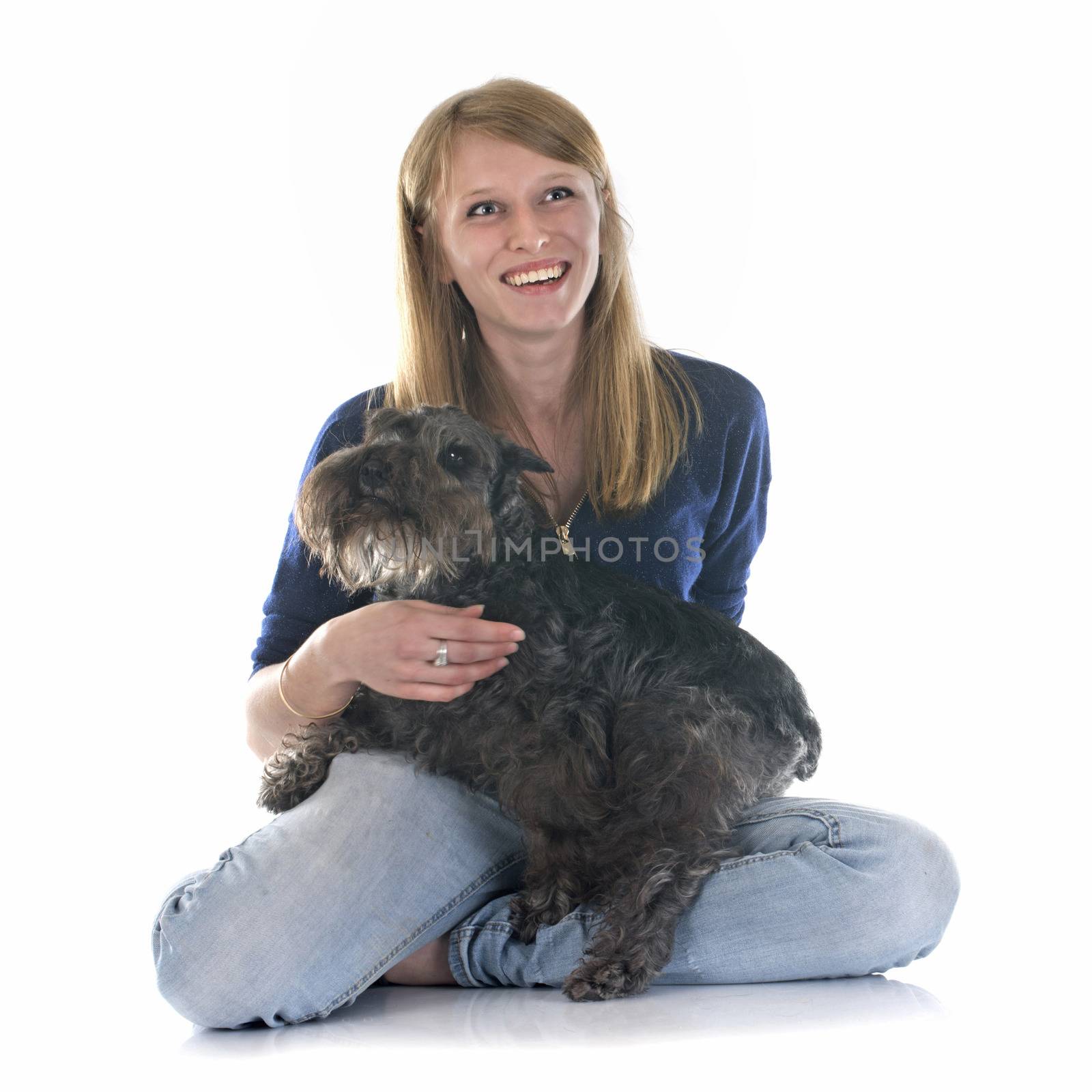 woman and miniature schnauzer in front of white background