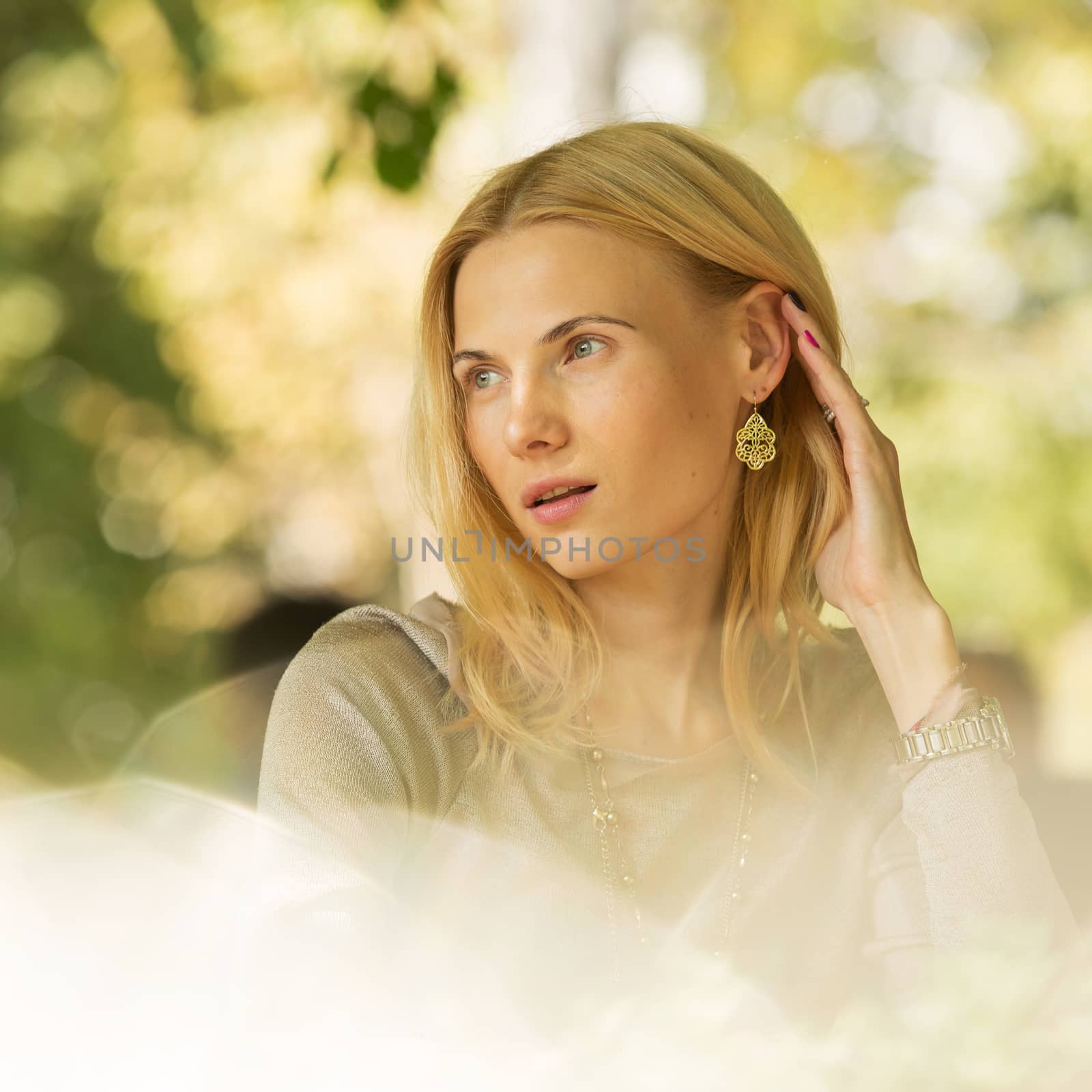 portrait of a beautiful young woman in park. by sarymsakov