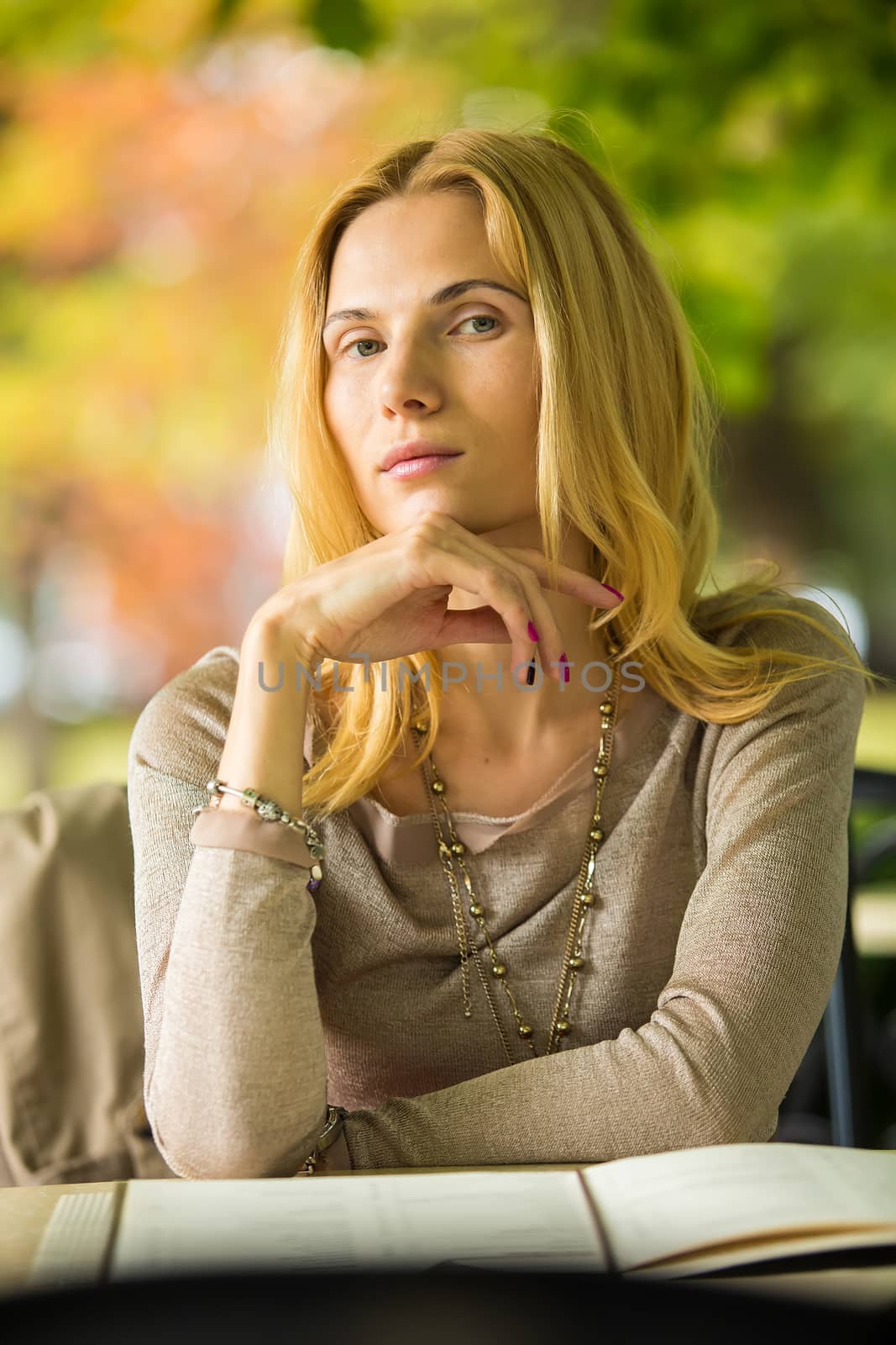 portrait of a beautiful young woman in park. by sarymsakov