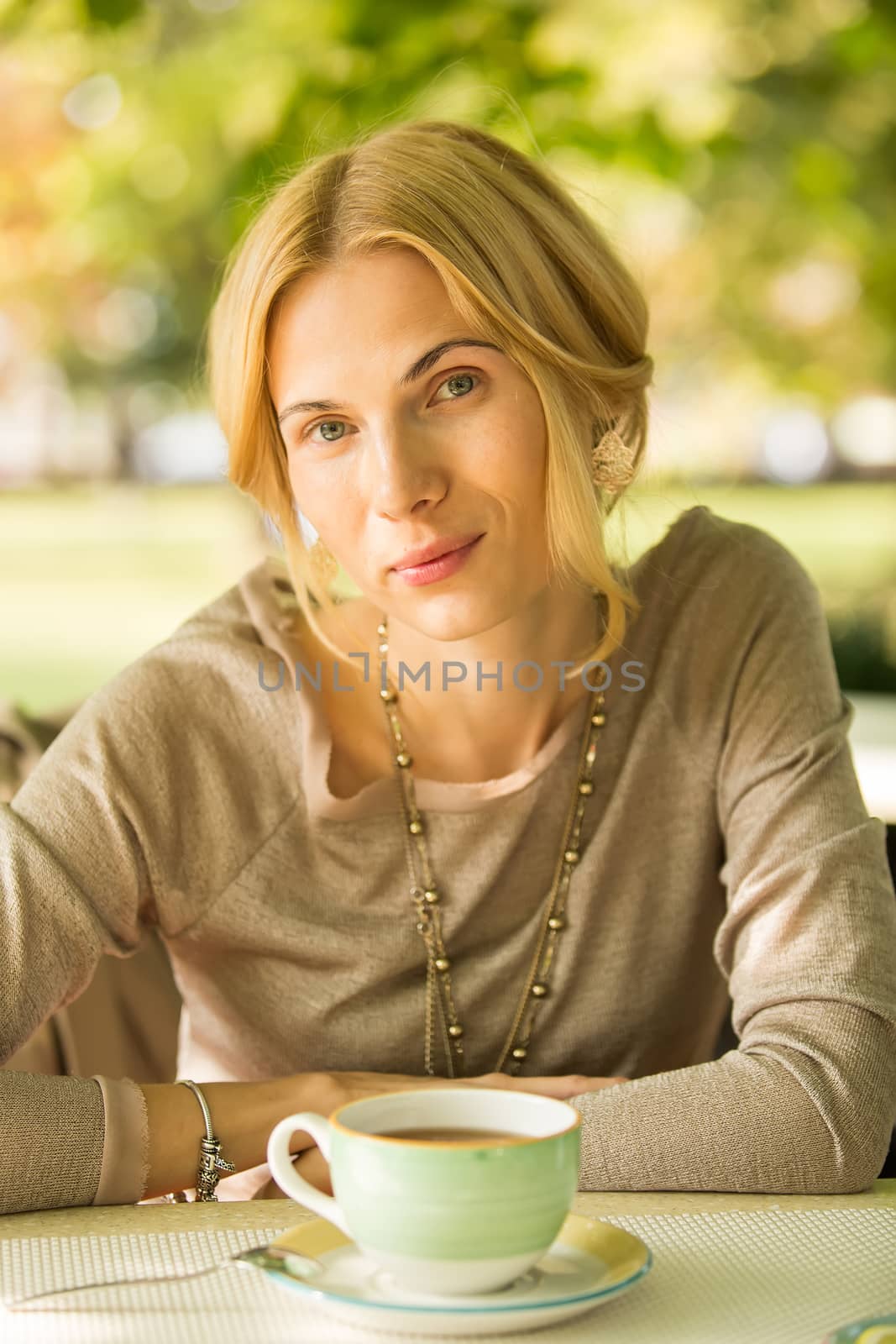 portrait of a beautiful young woman in park. by sarymsakov