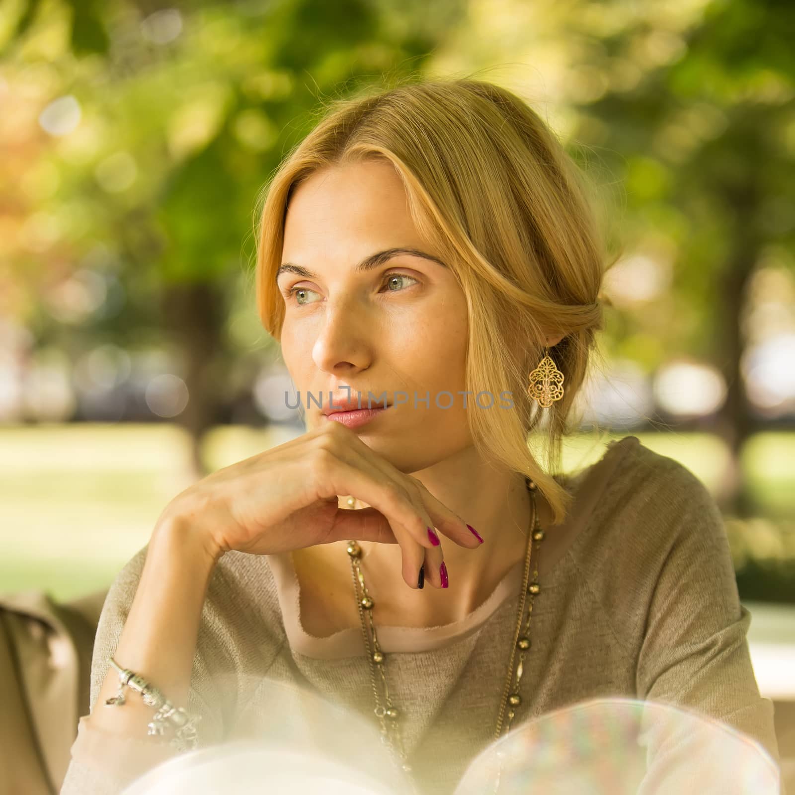 portrait of a beautiful young woman in park. by sarymsakov