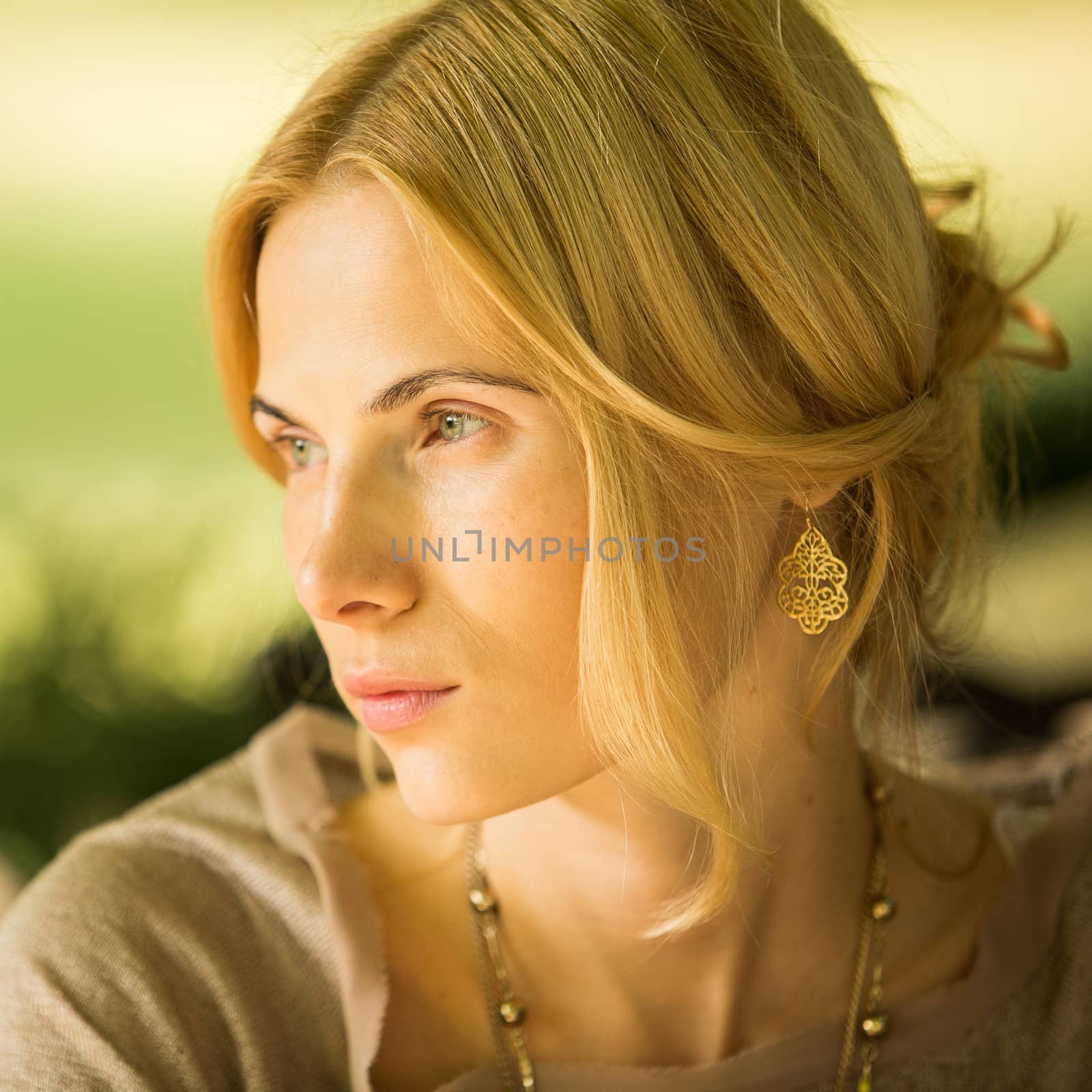 portrait of a beautiful young woman in a spring park. pictures in warm colors