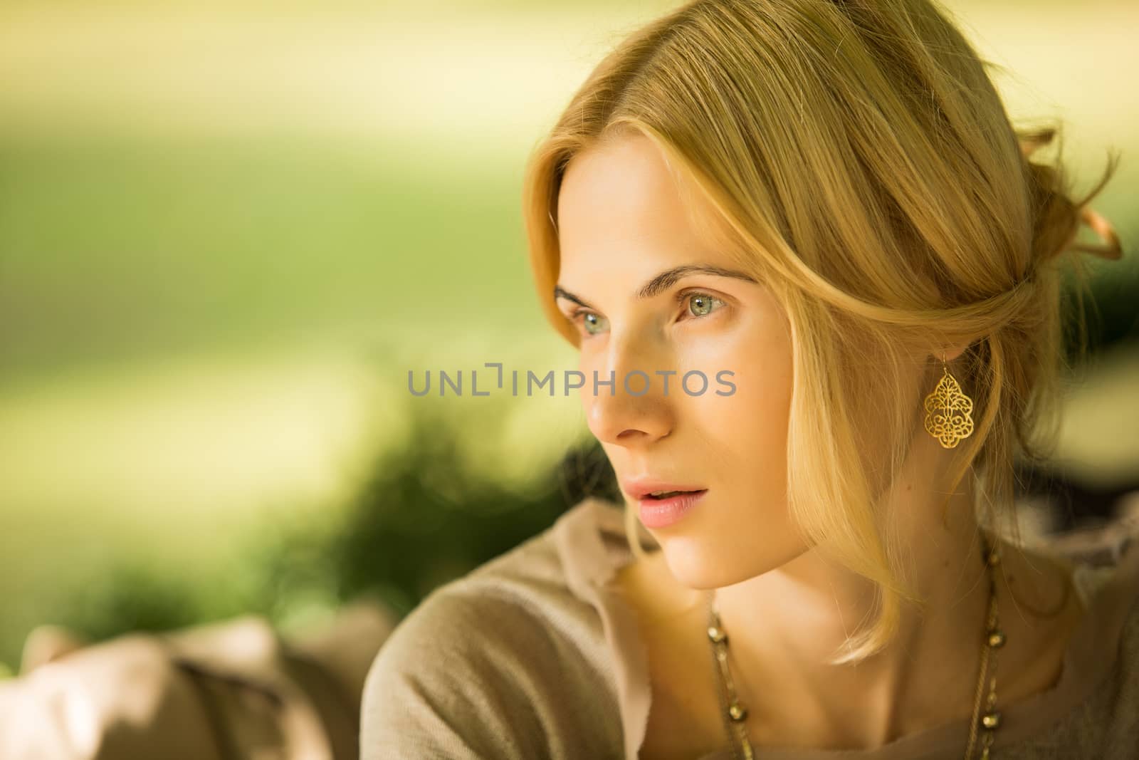 portrait of a beautiful young woman in a spring park. pictures in warm colors