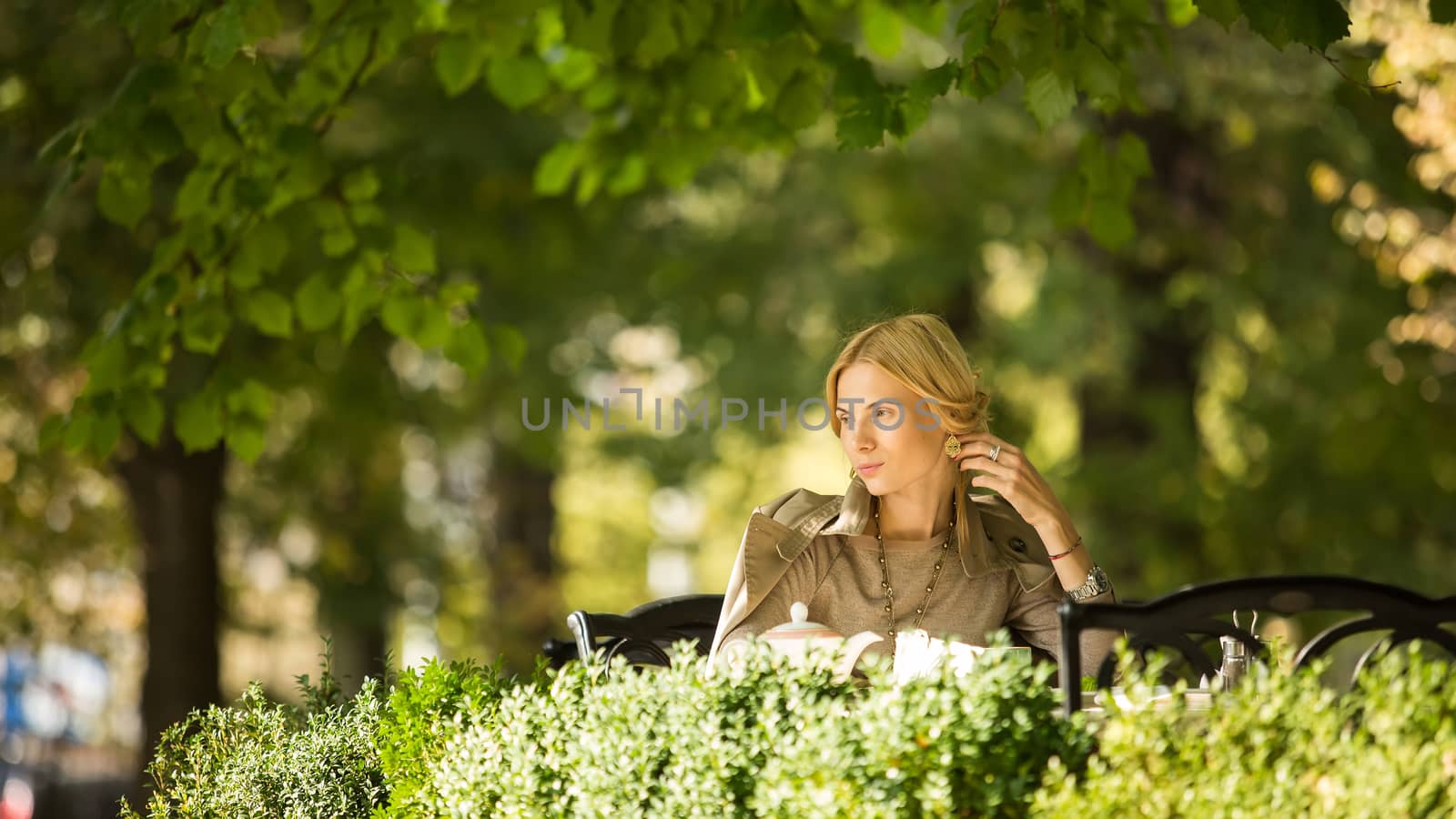 portrait of a beautiful young woman in park. by sarymsakov