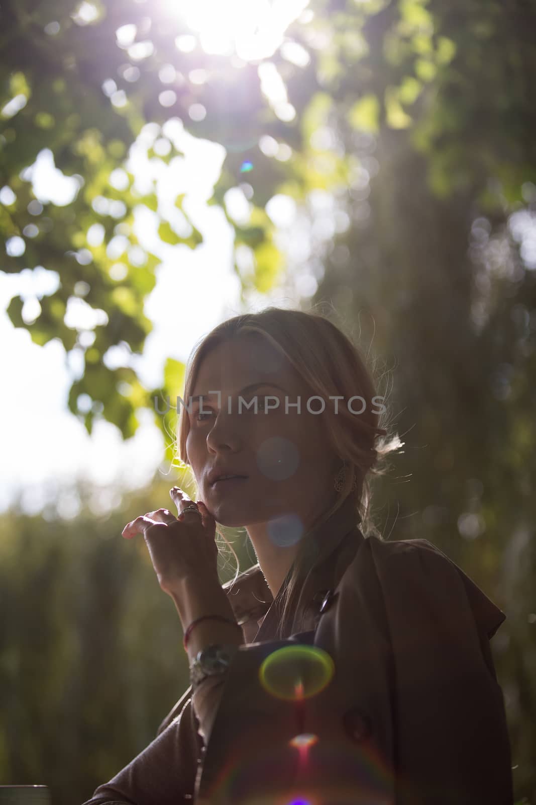 portrait of a beautiful young woman in a spring park. pictures in warm colors