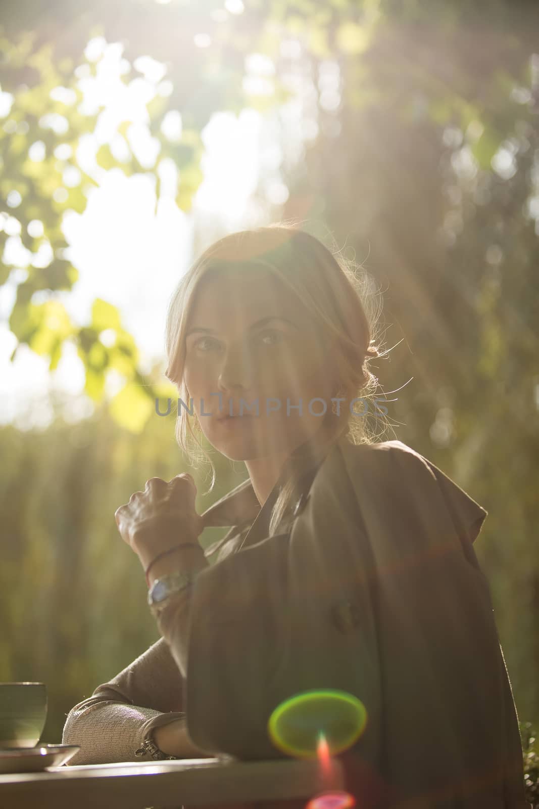 portrait of a beautiful young woman in park. by sarymsakov