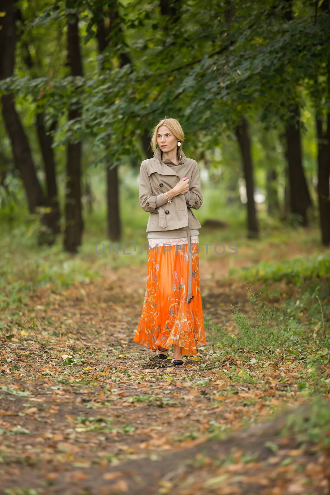 Young woman walking in forest by sarymsakov