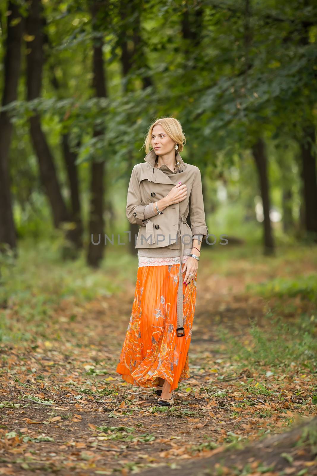 Young woman walking in forest by sarymsakov