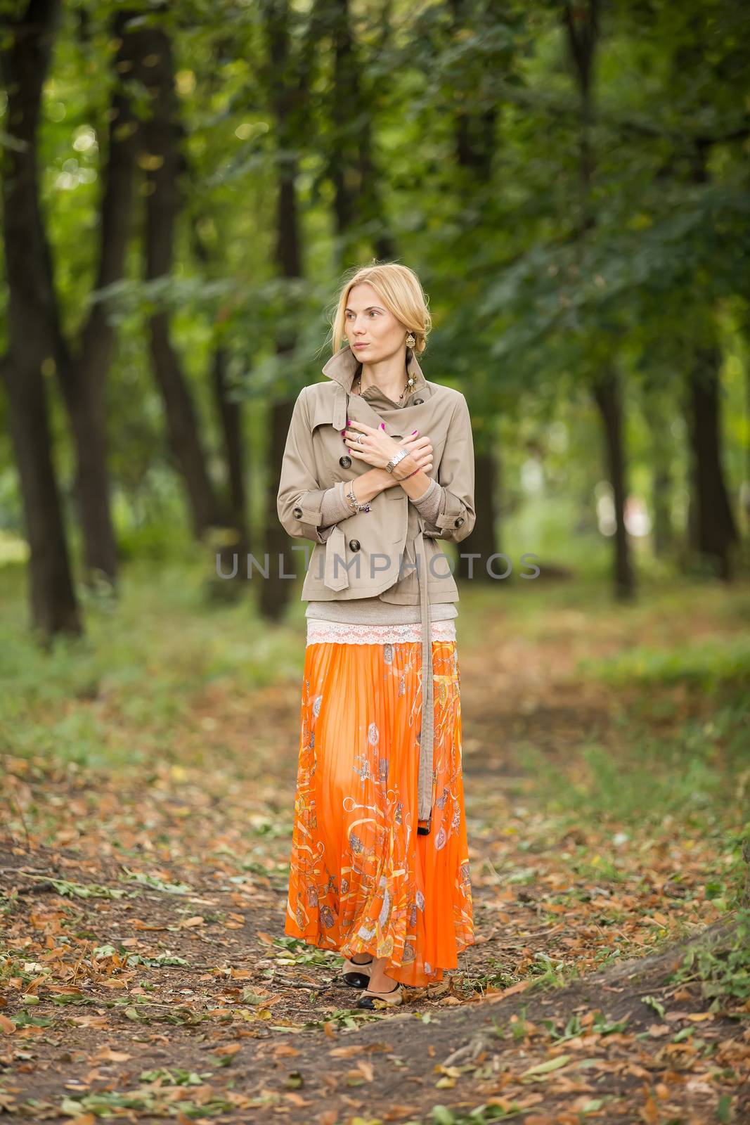 Young fashionable woman walking in spring park