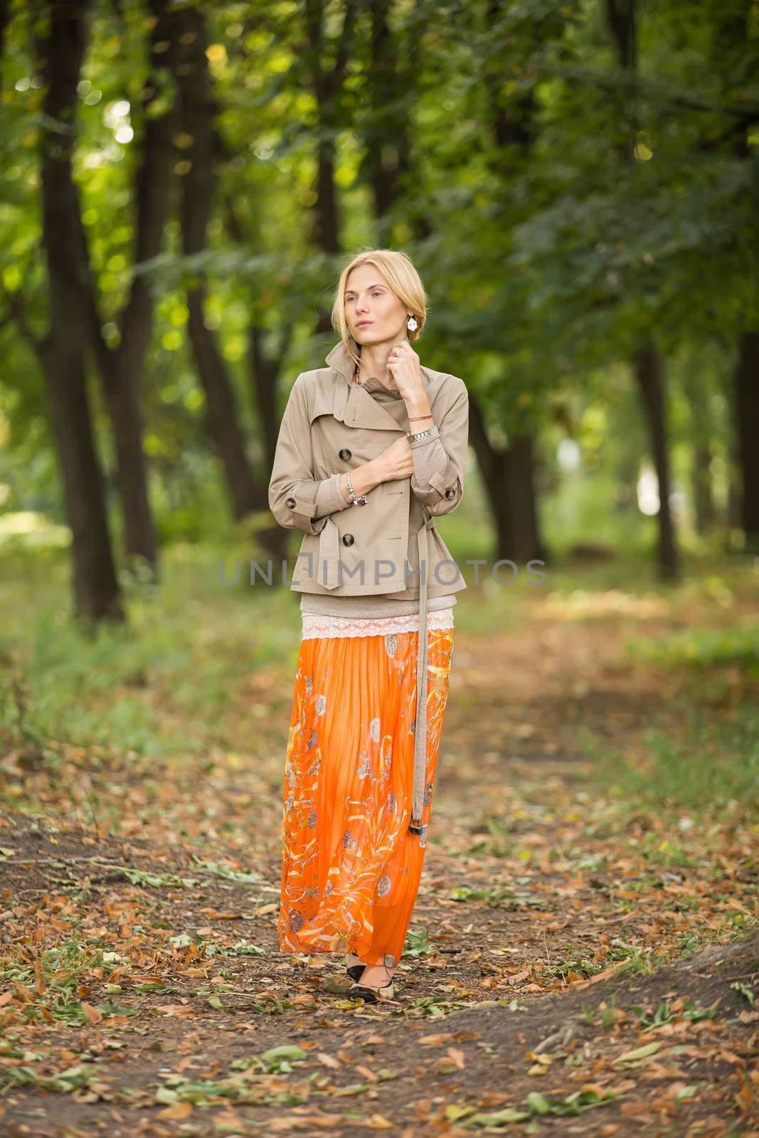 Young woman walking in forest by sarymsakov