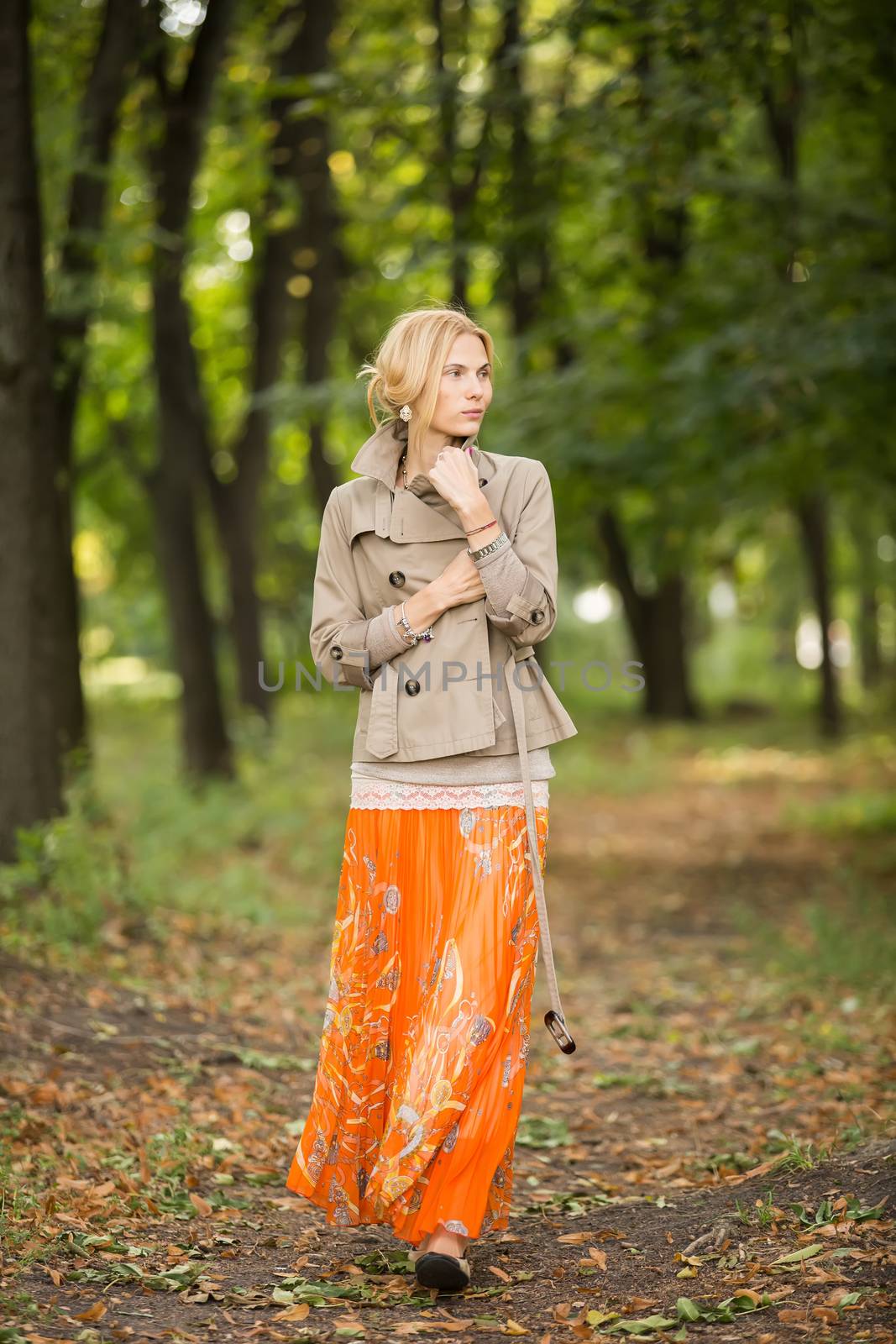 Young woman walking in forest by sarymsakov