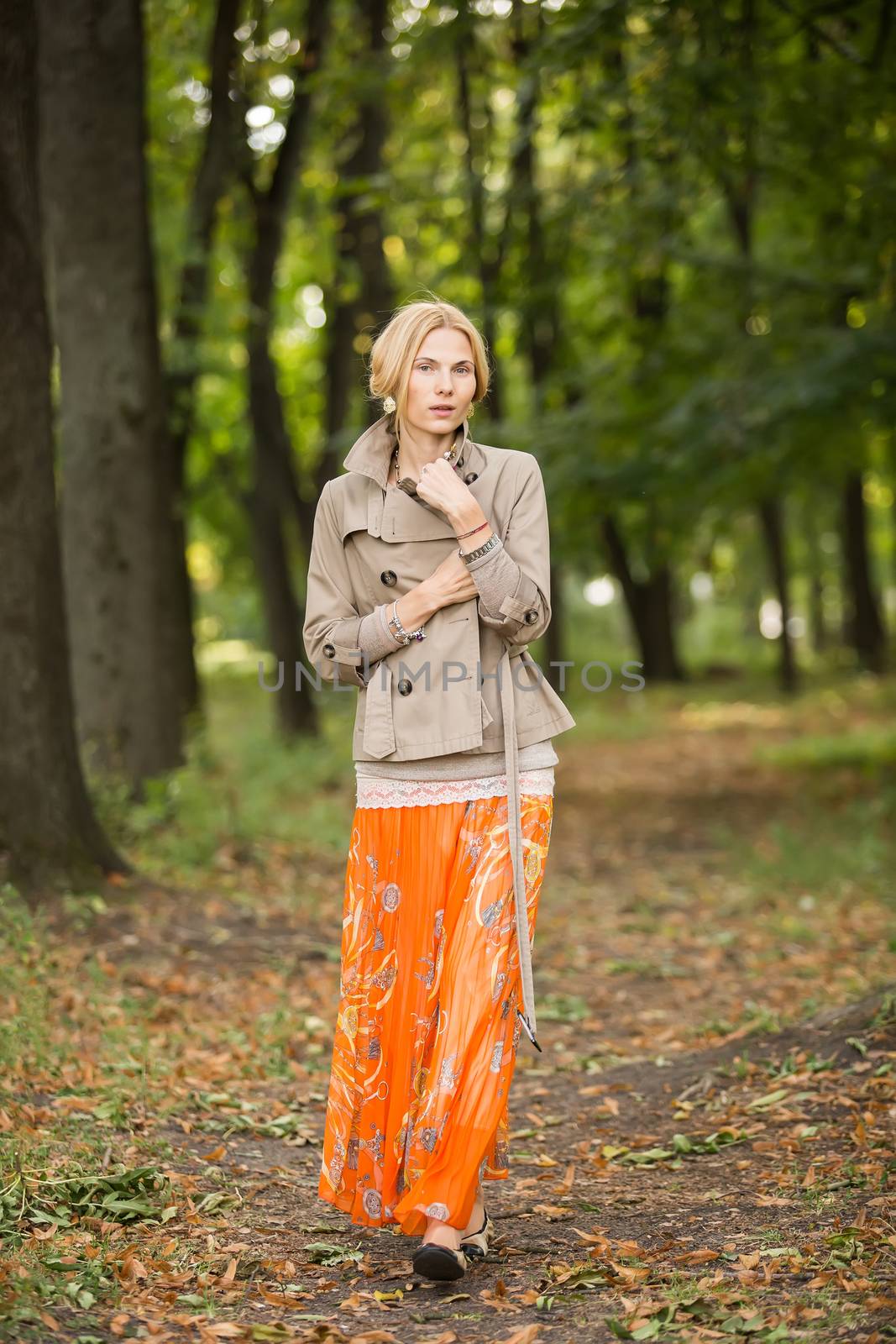 Young woman walking in forest by sarymsakov