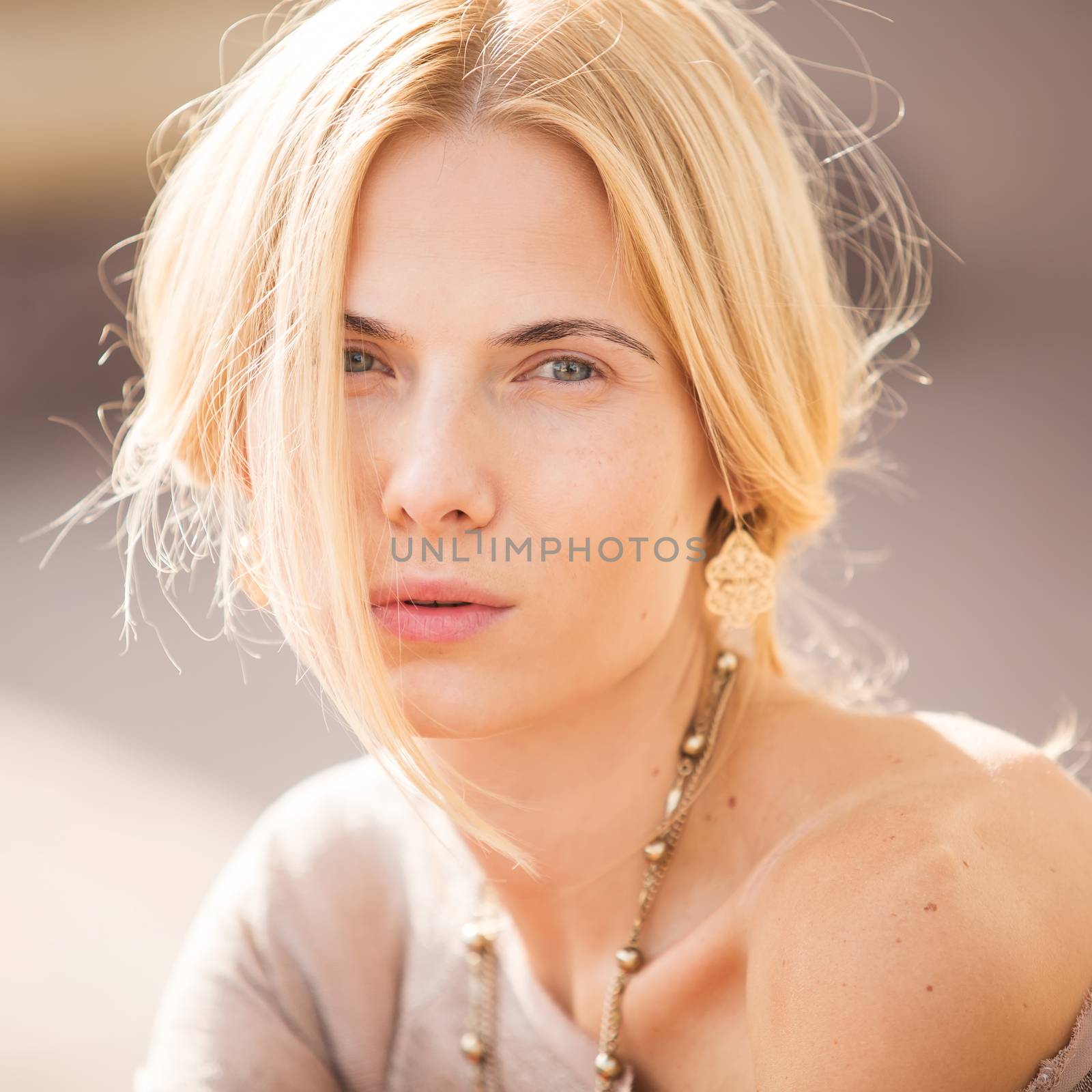 fashion portrait of a beautiful young woman on city background