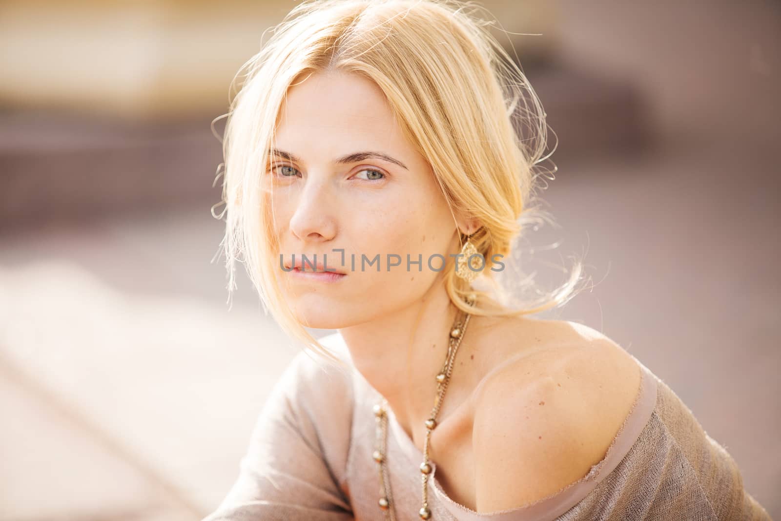 fashion portrait of a beautiful young woman on city background