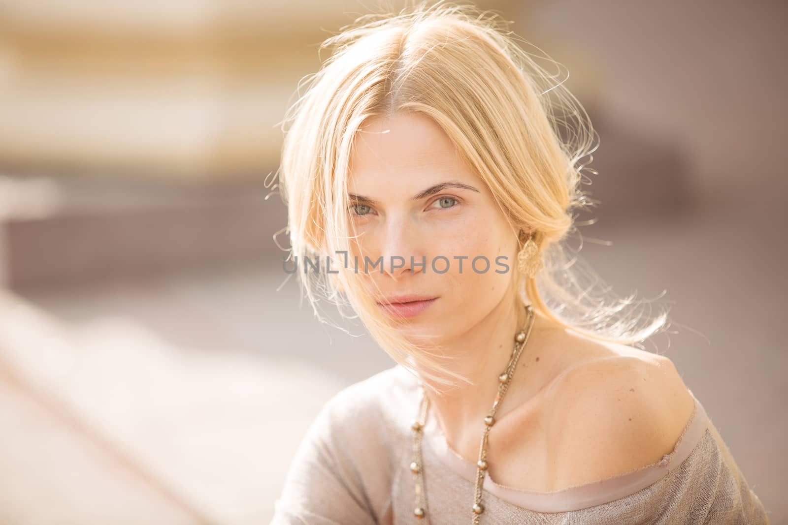 fashion portrait of a beautiful young woman on city background