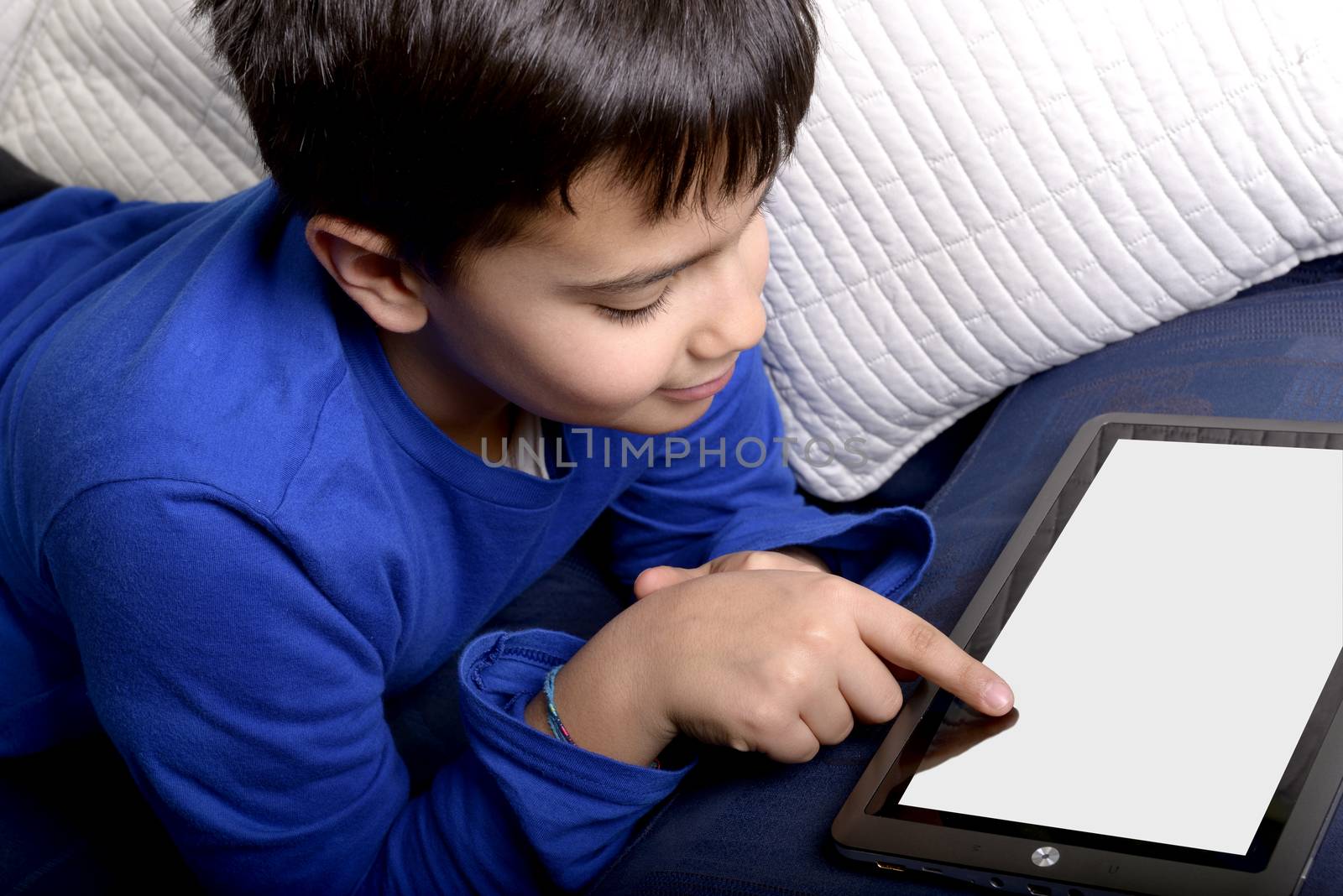 Child uses an iPad to communicate and play.