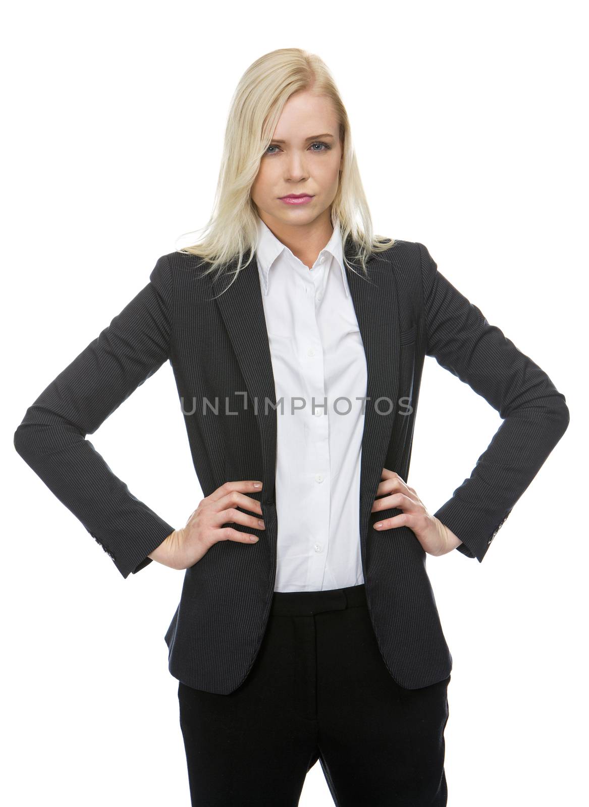 serious blonde businesswoman with arms resting on hips