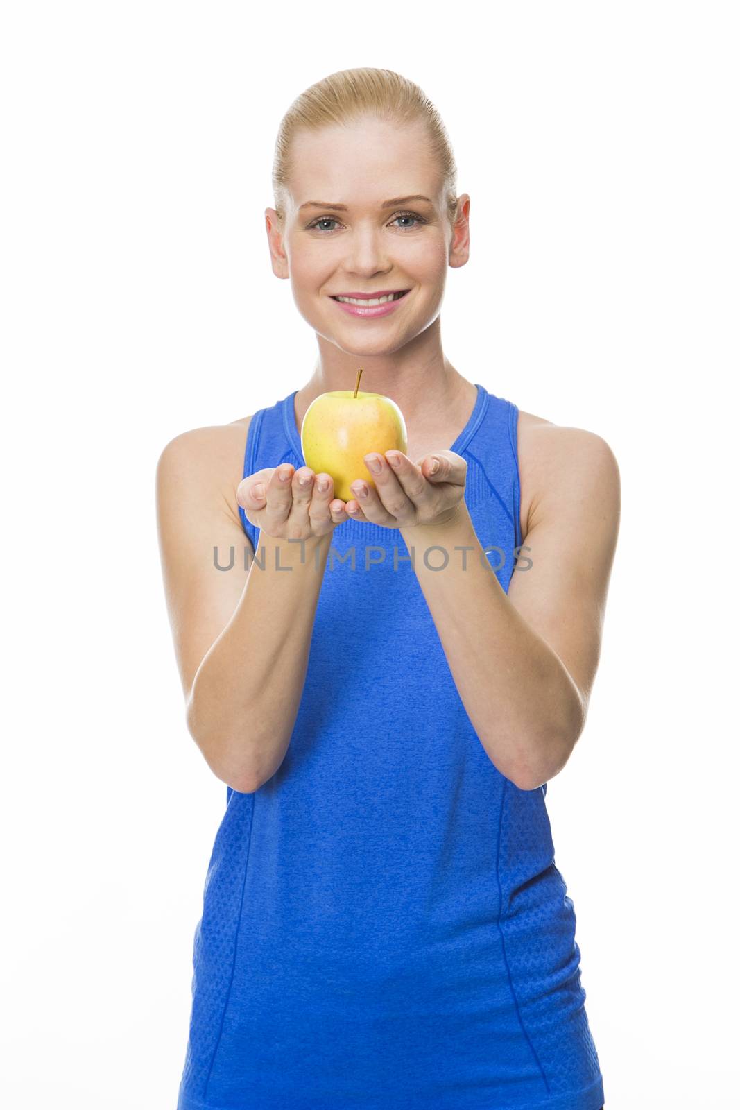 blonde smiling woman wearing fitness clothing and holding an apple with both hands