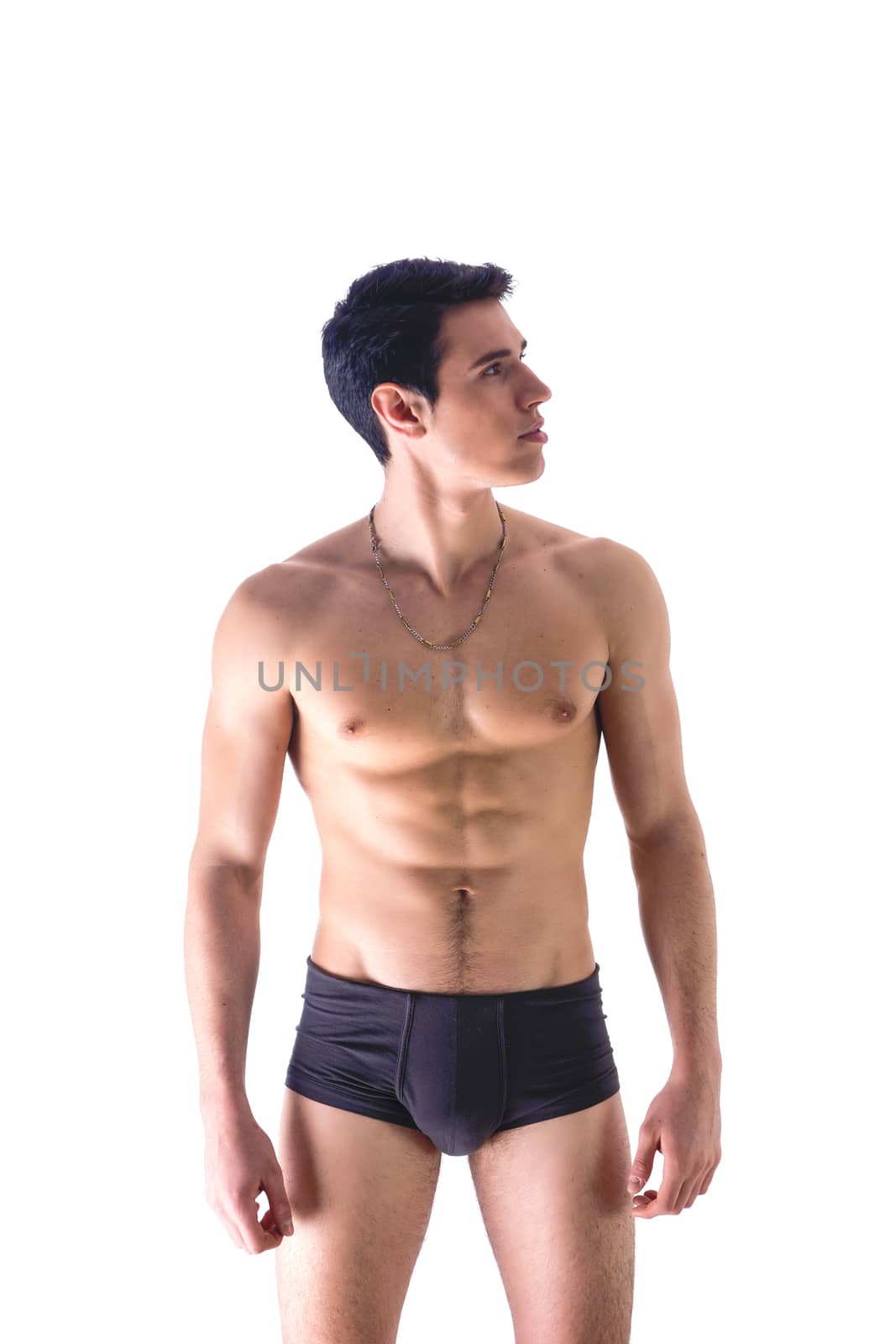 Handsome, fit young man wearing only underwear standing isolated on white by artofphoto