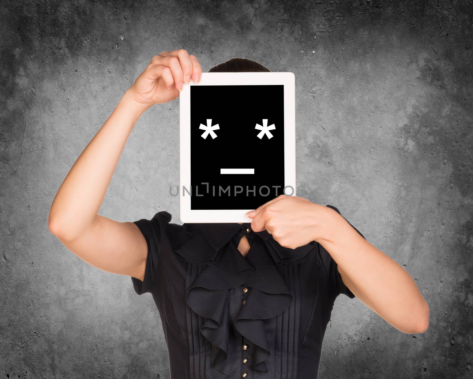 Girl in black dress covered her face with tablet. On screen code smiley. Concrete background