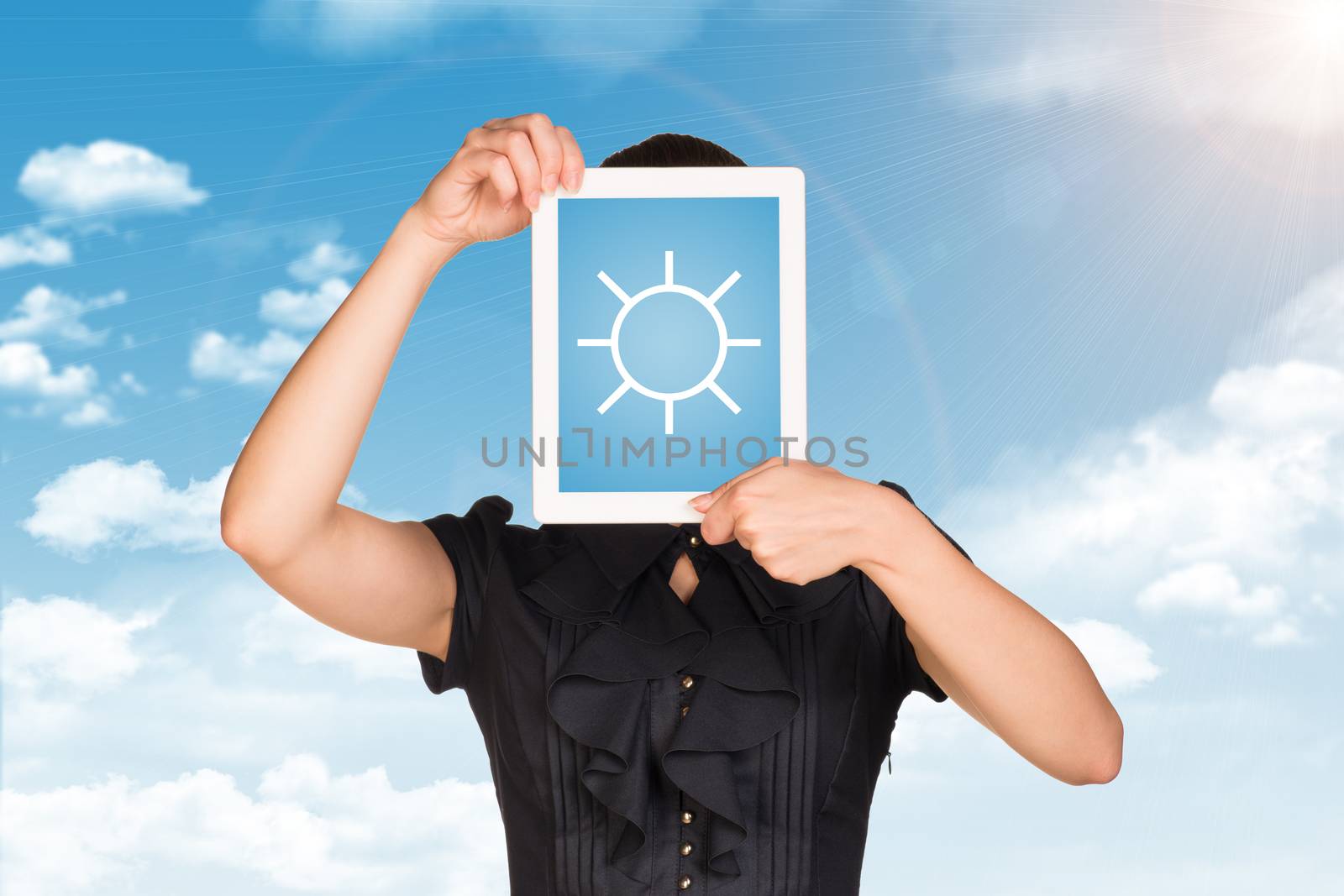 Girl in dress covered her face with tablet. On screen sun symbol. Blue sky with clouds as backdrop