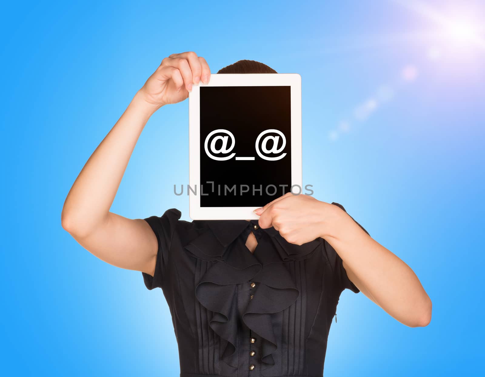 Young girl in dress covered her face with tablet. On screen code smiley. Blue sky with sun light as backdrop