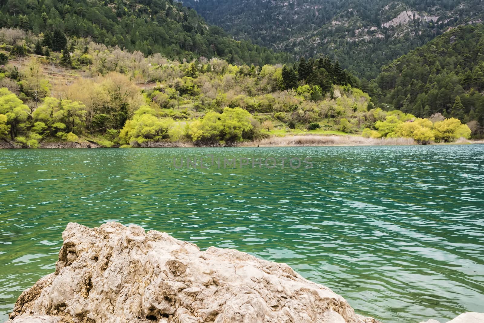 Mountain green lake view with rock