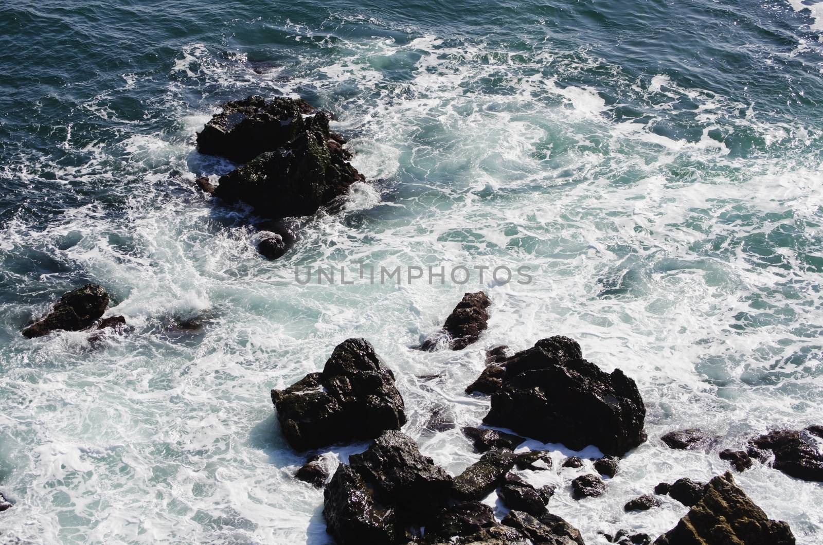 Wavy Black Sea With Stones
