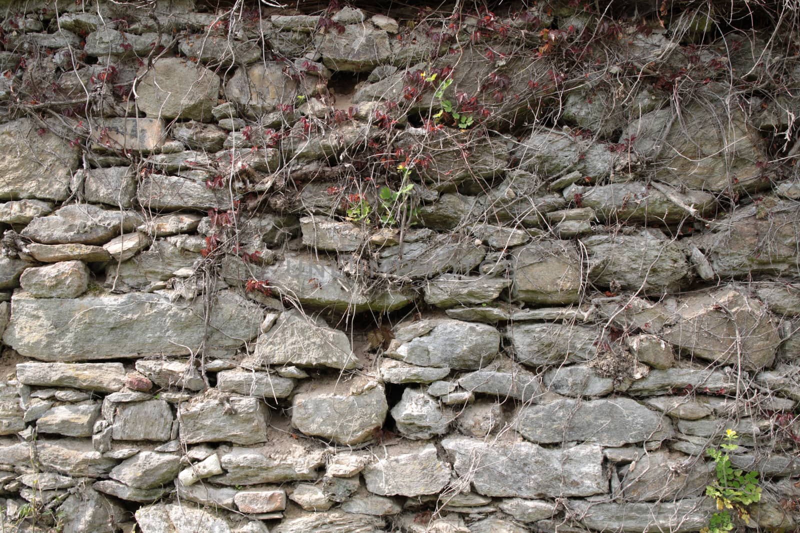 Old shabby wall of large hewn stones
