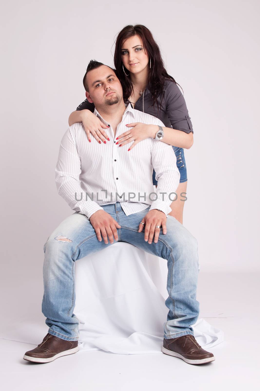 Young woman rests behind the seated young man