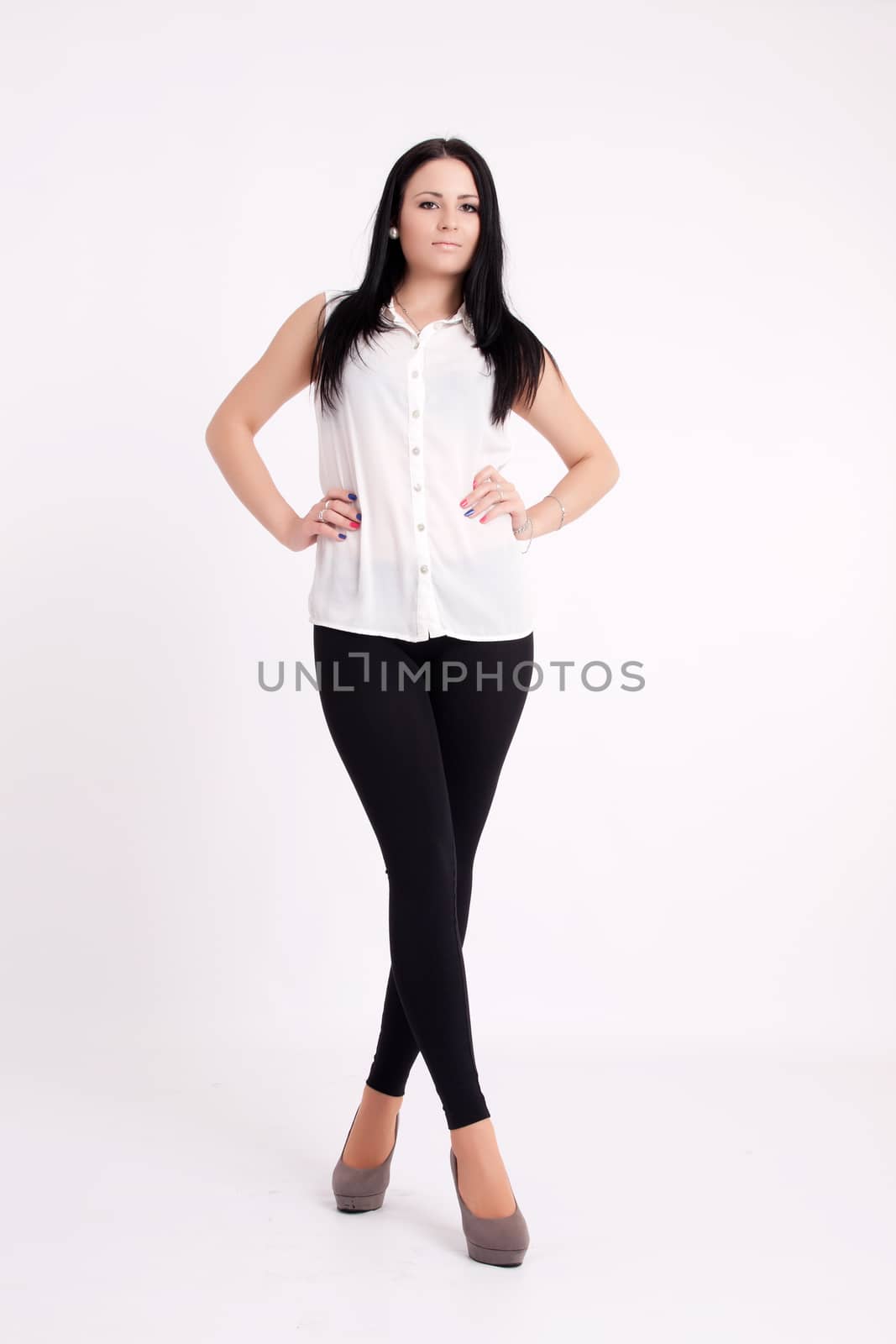 Young long-haired black-haired woman posing in studio