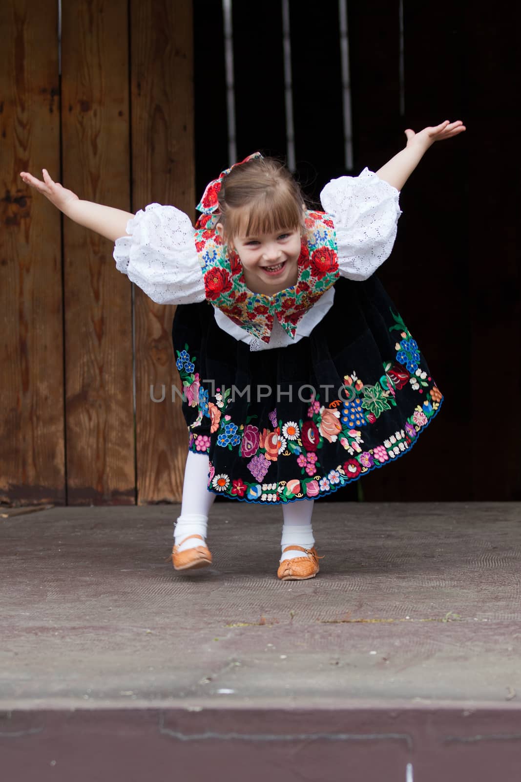 Smiling, happy little girl in traditional costume