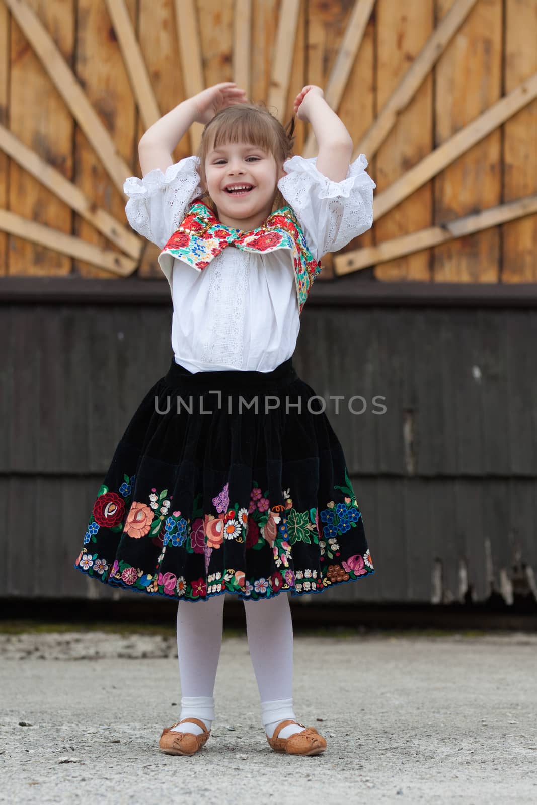 Smiling, happy little girl in traditional costume