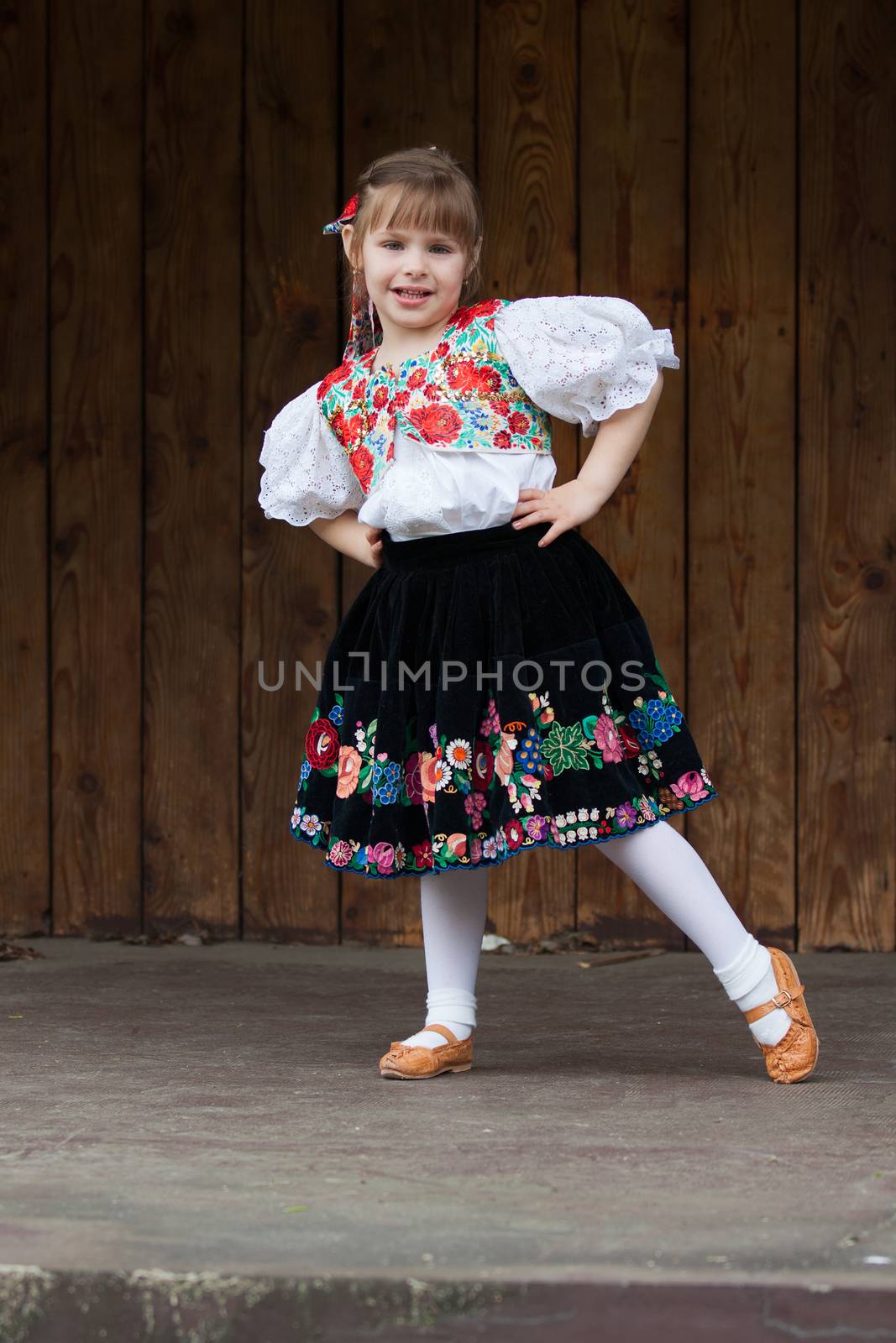 Smiling, happy little girl in traditional costume