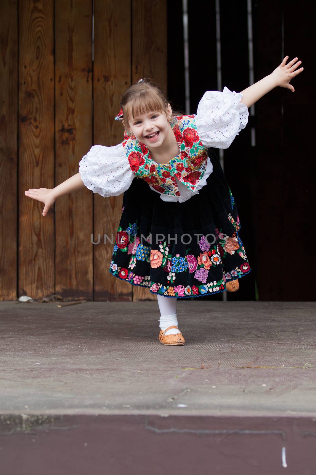 Smiling, happy little girl in traditional costume