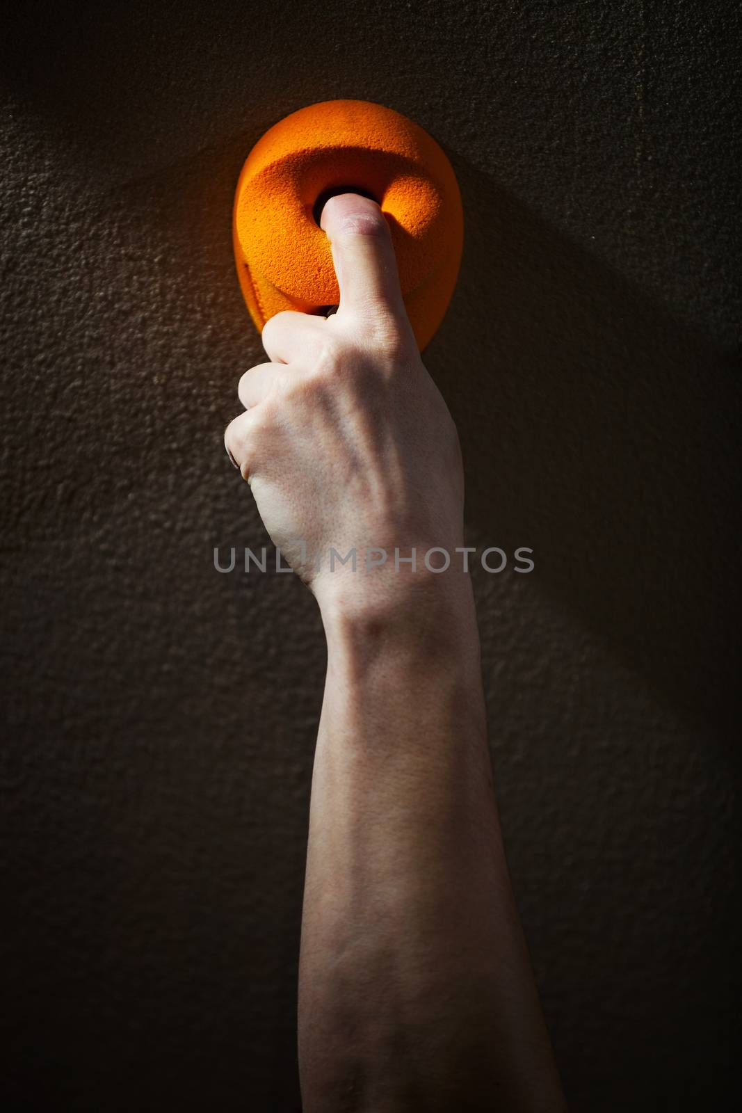 Close up of man gripping handhold with one finger by photobac