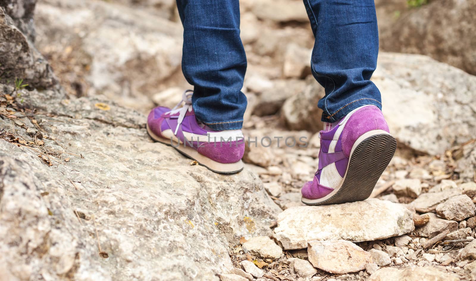 Cropped view of woman walking along trail in mountains