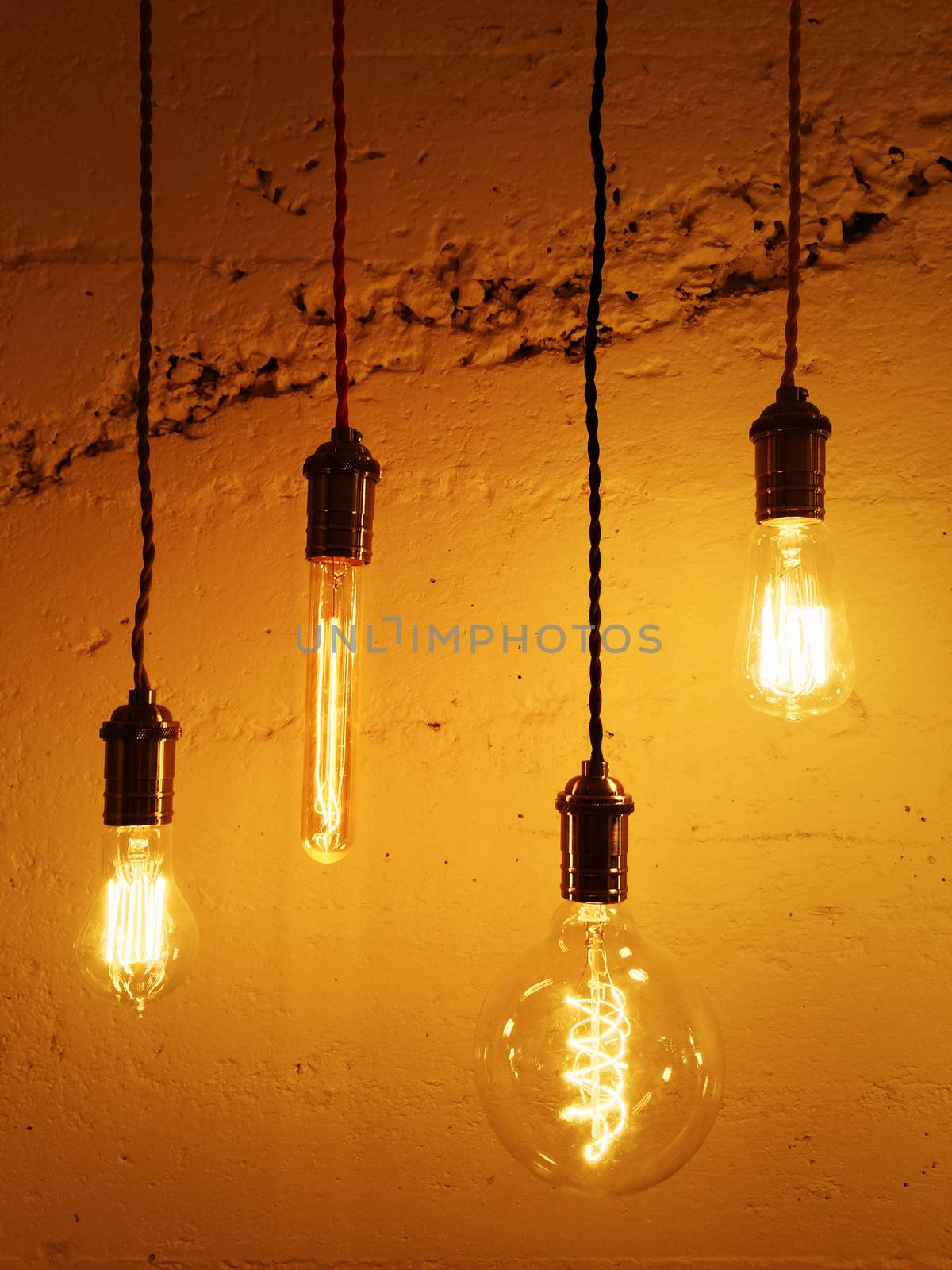 Illuminated light bulbs on concrete background. Modern design. 