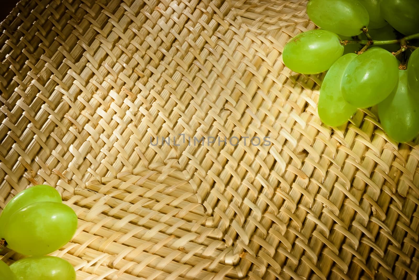 Background. The Frame. Wicker texture with green grapes on the corners