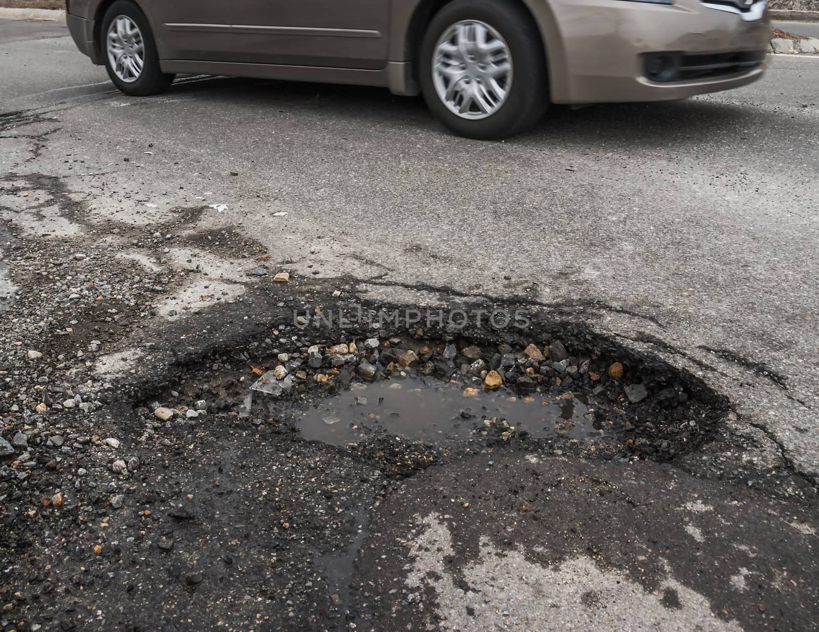 Big pothole in road by f/2sumicron