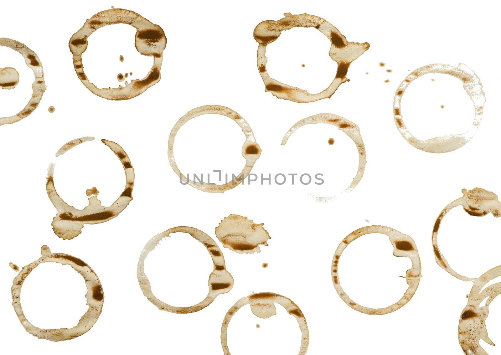 Lot of circle shape coffee stains on white background.