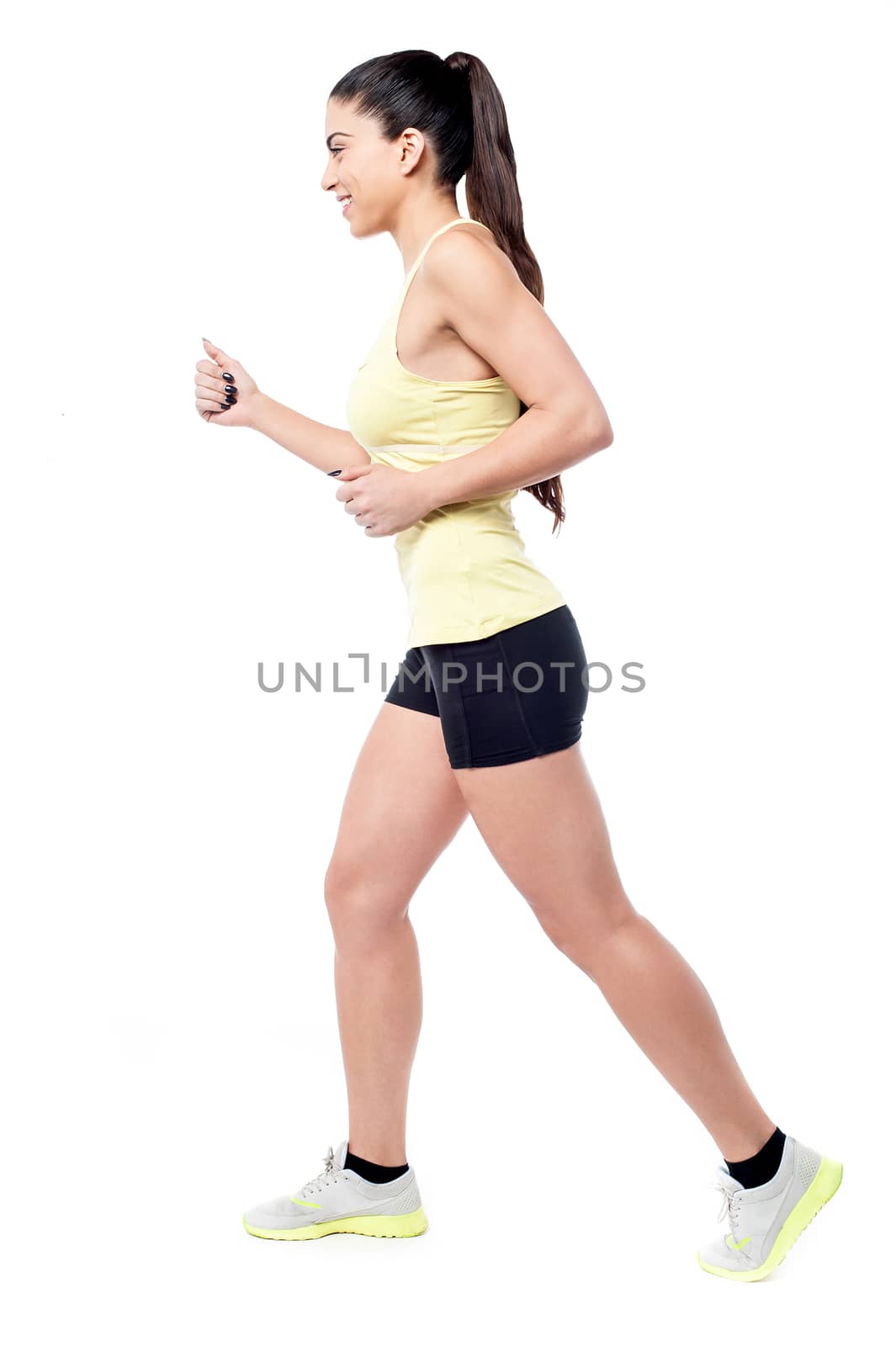 Sideways of young athletic woman jogging