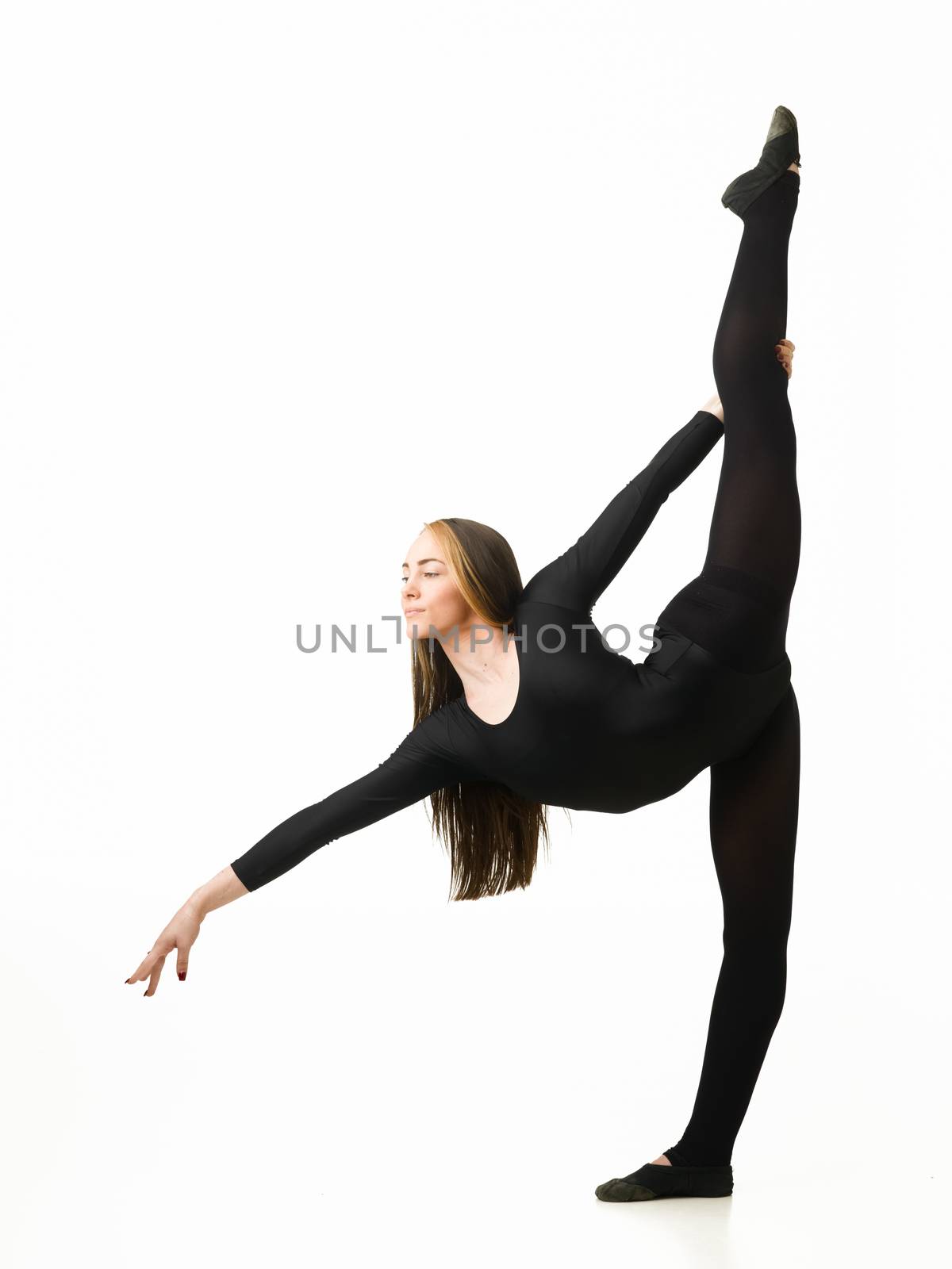 young beautiful female gymnast stretching out on white background