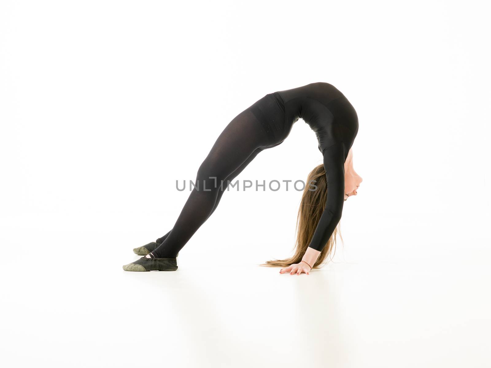 young girl doing gymnastics bridge isolated on white background