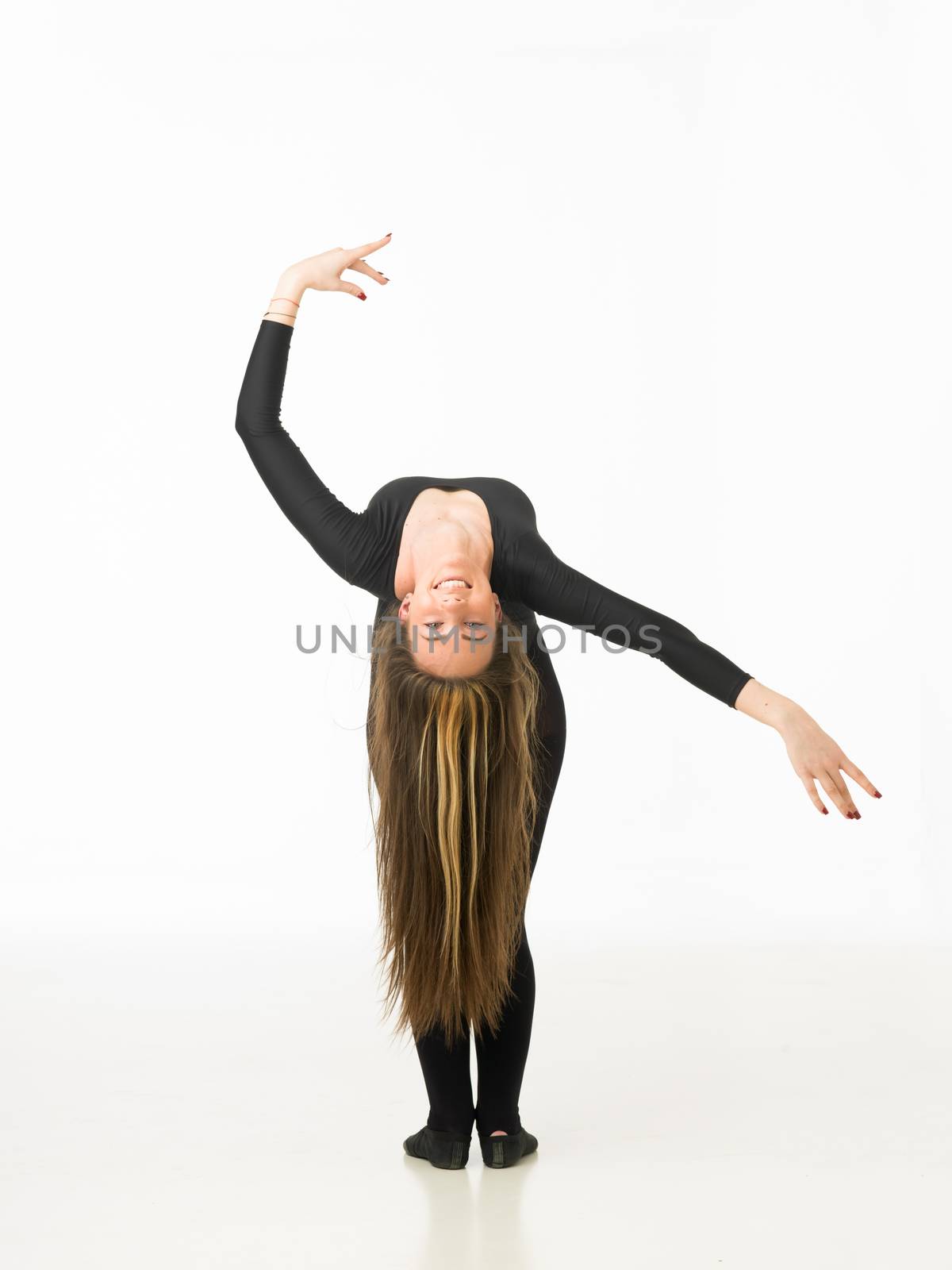 beautiful caucasian happy female dancer posing in studio, on white background