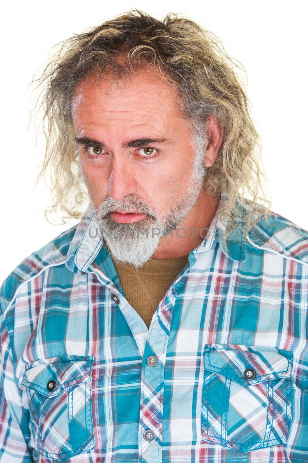 Mature adult with dissatisfied expression over white background