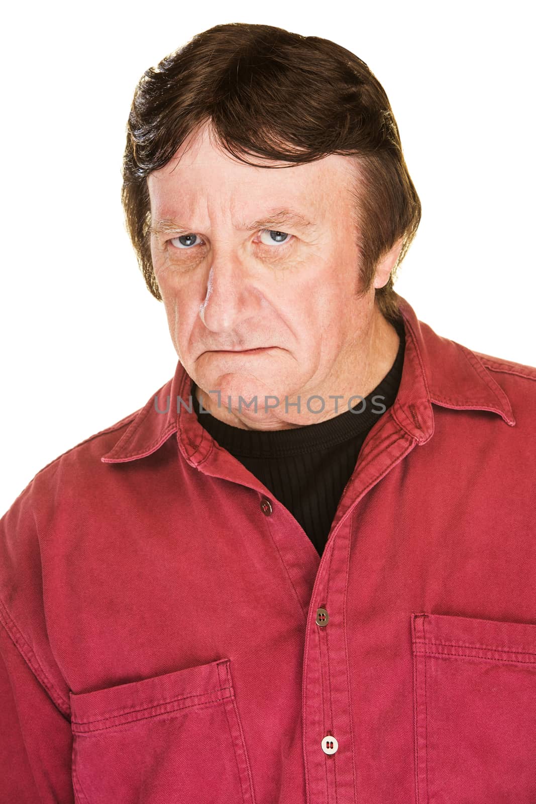 Suspicious man in red frowning over white background